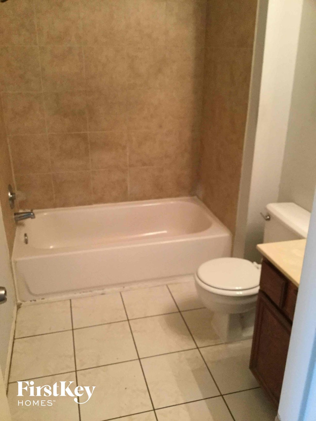 a bathroom with a toilet and a bath tub