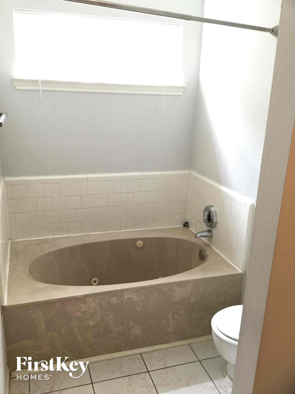a small bathroom with a bath tub and a toilet