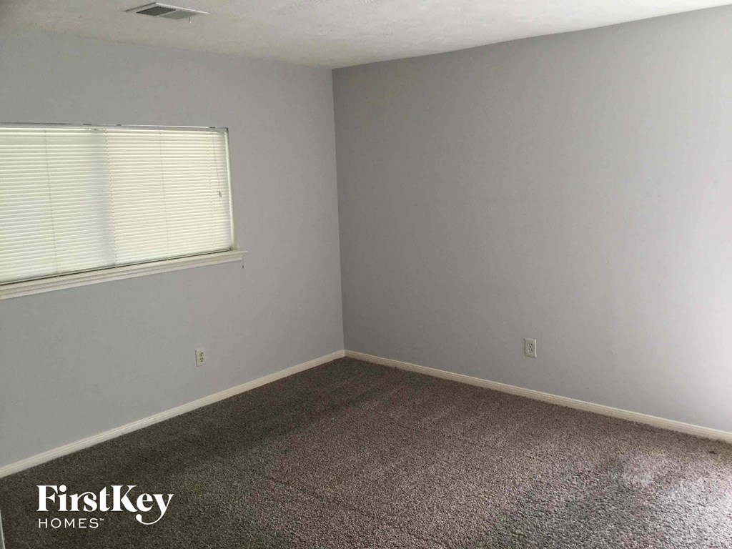 a room with a carpet and a window