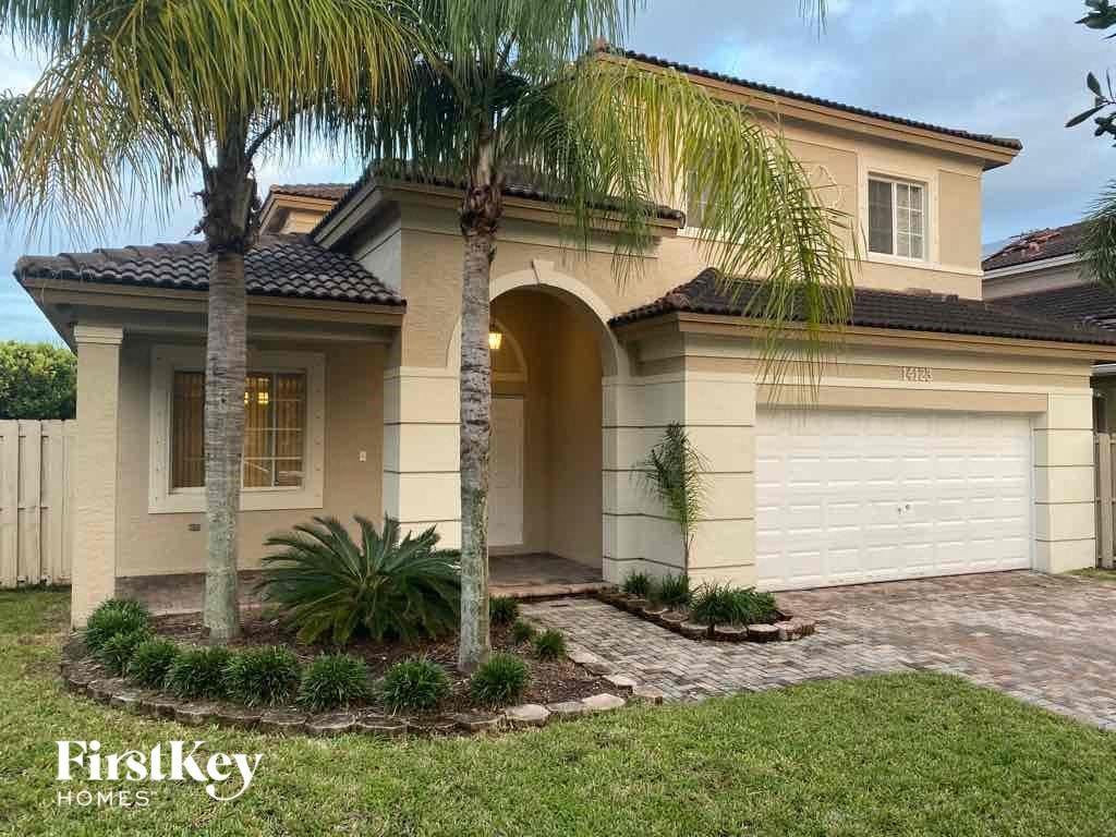 A house with a palm tree in front of it.