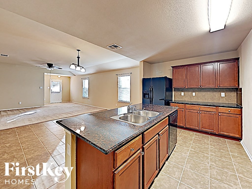 A kitchen with a sink and cabinets.