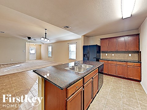 A kitchen with a sink and cabinets.