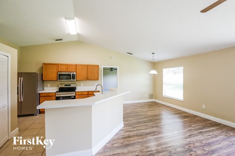 A kitchen with wooden cabinets and a white island.