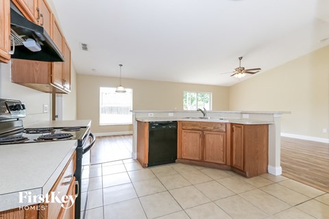 a kitchen with wooden cabinets and a stove and a sink