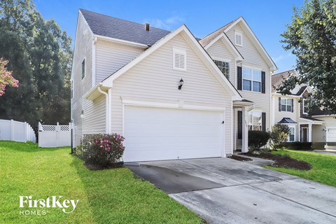 A white house with a garage is for sale by FirstKey Homes.