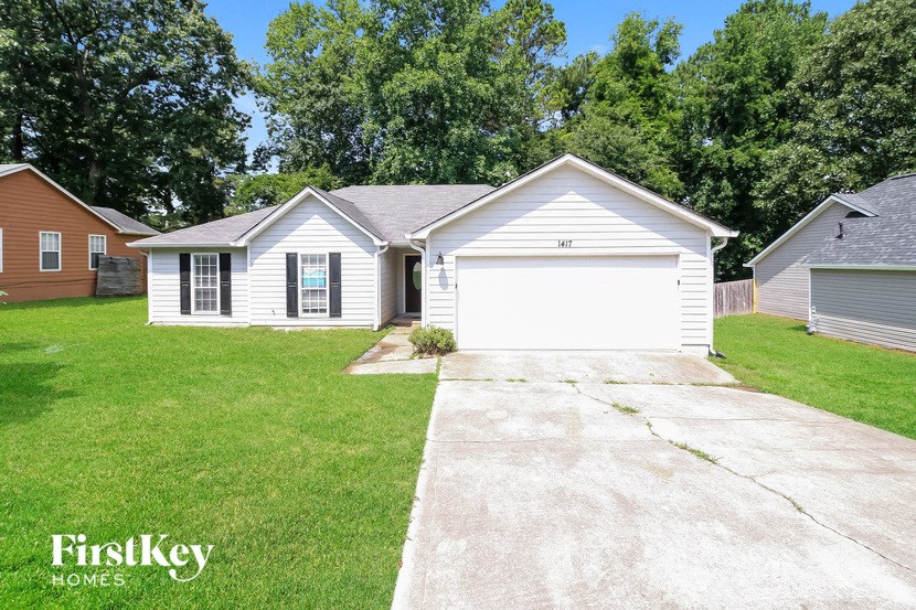 a white house with a driveway and a white garage door