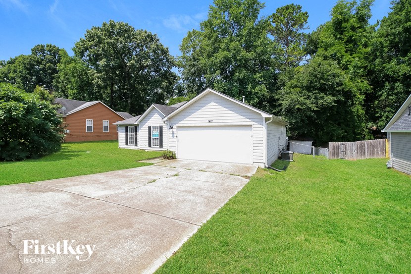 a white garage with a white door and a driveway