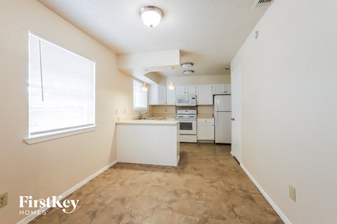 A kitchen area with a white counter and appliances.