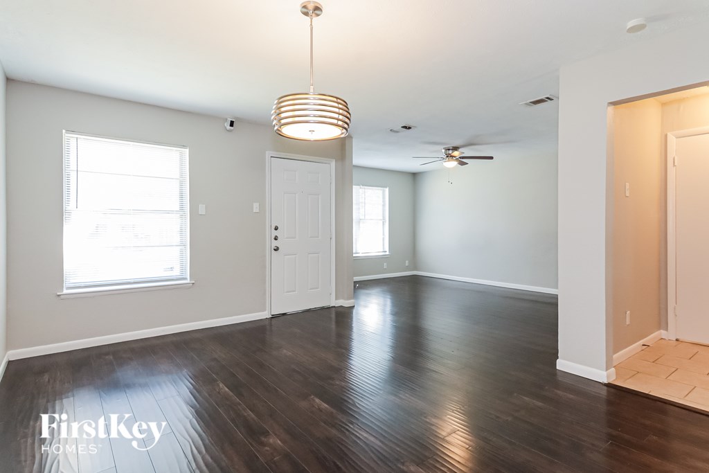A room with wooden floors and a ceiling fan.