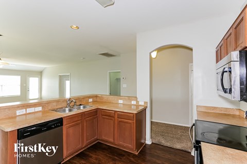 a kitchen with wooden cabinets and a sink and counter top