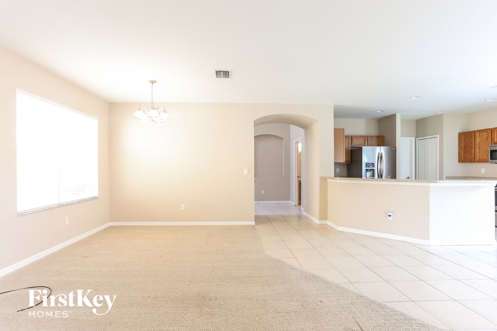 an empty living room and kitchen in a house
