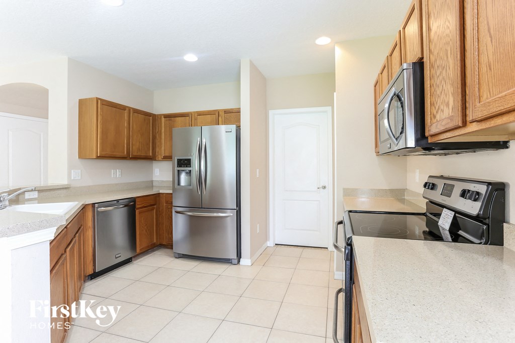 a kitchen with stainless steel appliances and wooden cabinets