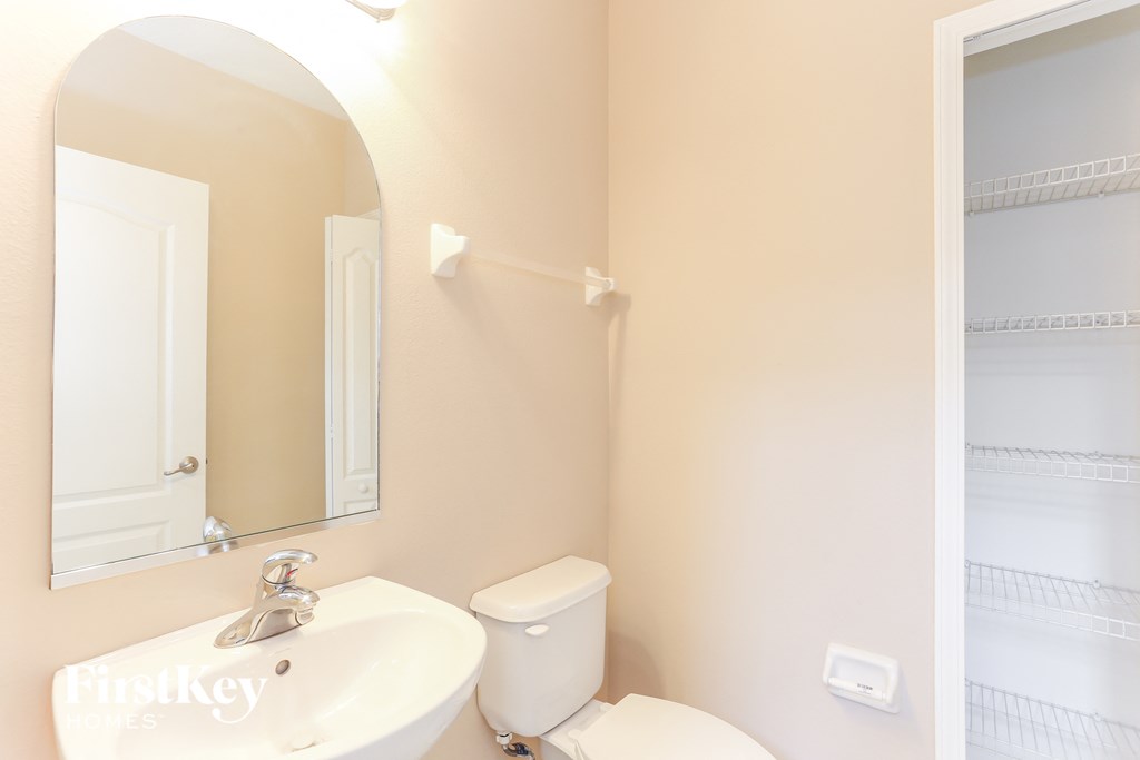 a bathroom with a sink and a mirror and a toilet