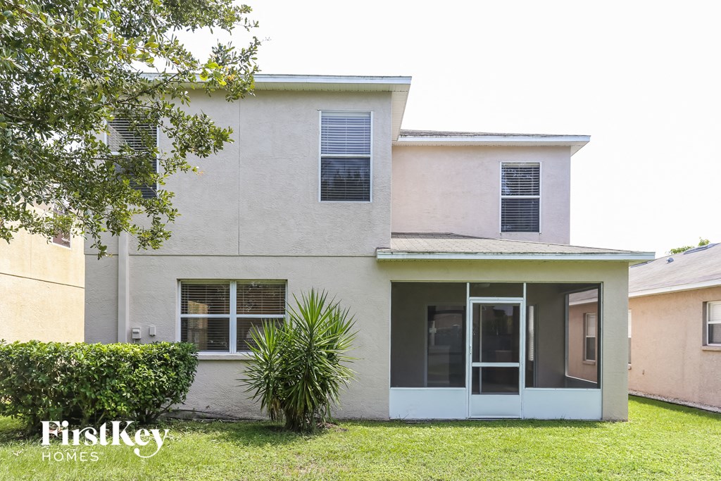 a white house with a palm tree in front of it