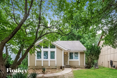 A small house with a tree in front of it.
