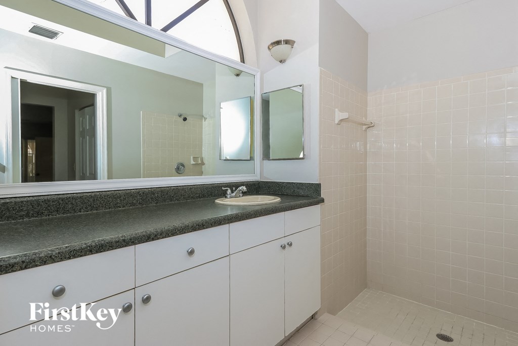 a bathroom with a sink and a mirror and a window