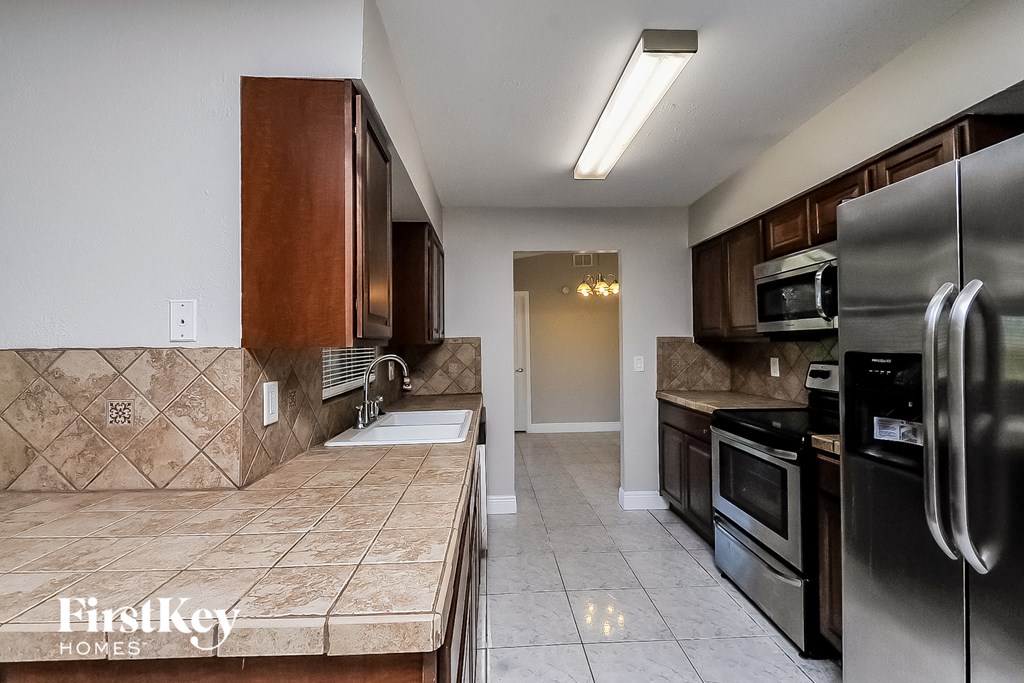 a kitchen with stainless steel appliances and wooden cabinets