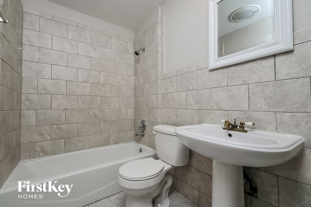 a bathroom with a sink toilet and a bath tub