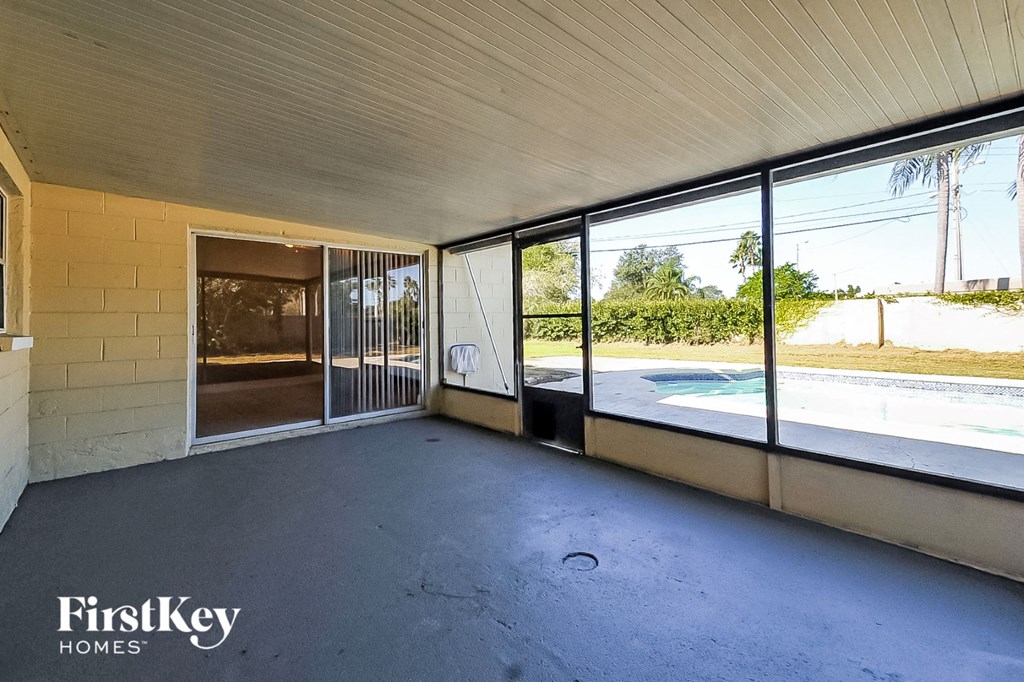 a large room with glass doors to a swimming pool