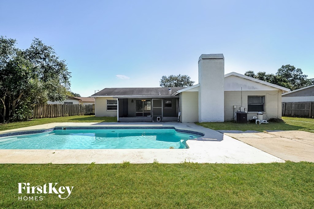 a backyard with a pool and a house