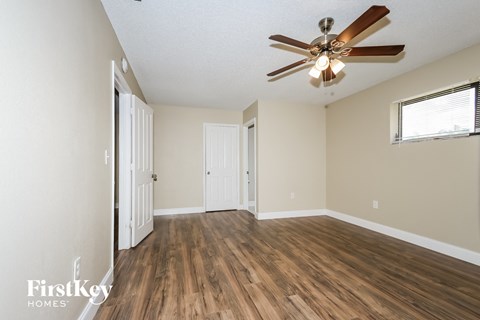 a living room with hardwood floors and a ceiling fan