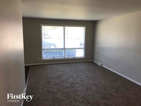 an empty living room with a large window