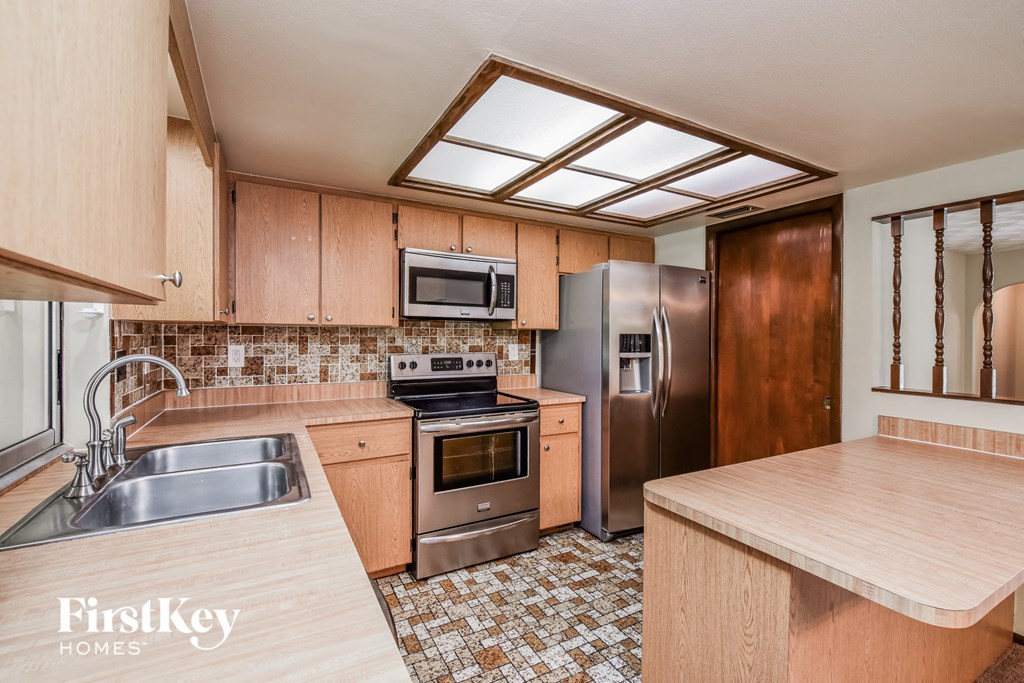 a kitchen with stainless steel appliances and wooden cabinets