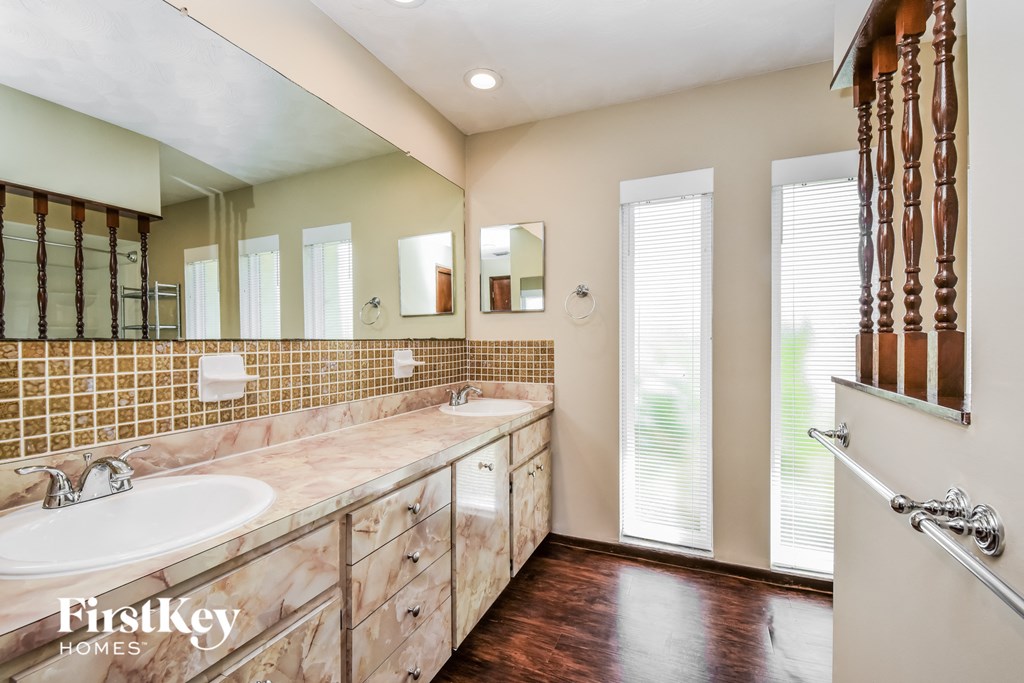 a large bathroom with two sinks and a large mirror