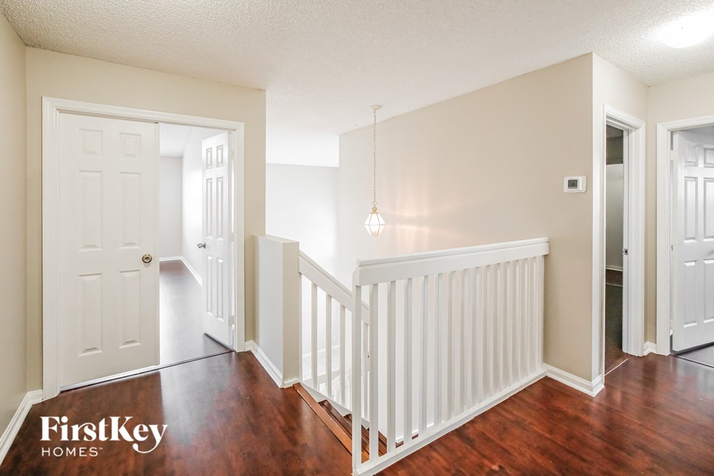 A well lit hallway with a FirstKey Homes logo.