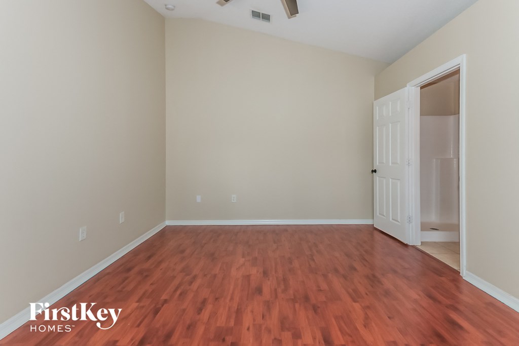 a living room with wood flooring and a white door