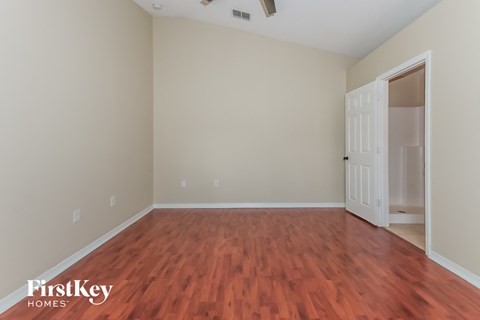 a living room with wood flooring and a white door