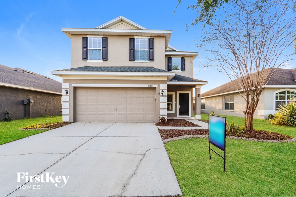 A house with a sign in front of it that says FirstKey Homes.