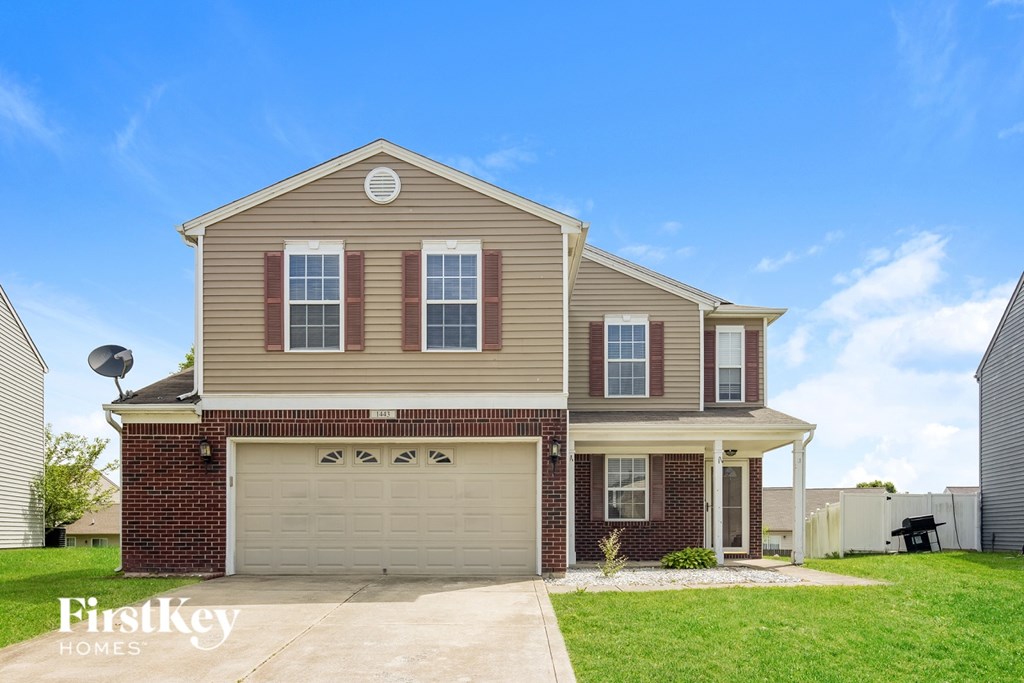 A two-story house with a garage is for sale.