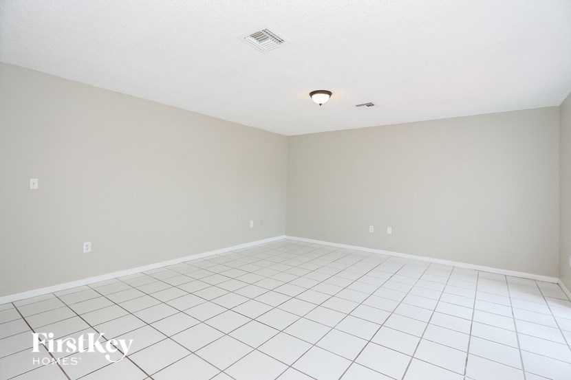 an empty room with a white tiled floor