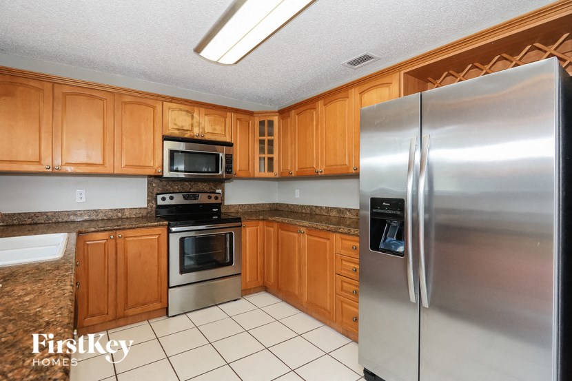 a kitchen with stainless steel appliances and wooden cabinets