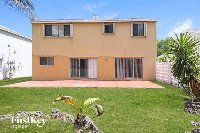 a house with a yard and a palm tree