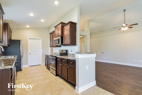 a kitchen with wooden cabinets and stainless steel appliances