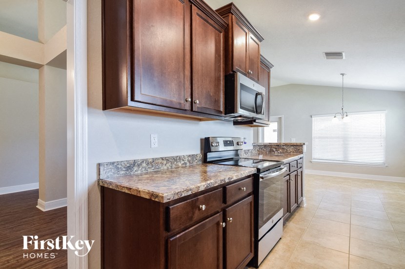 a kitchen with wooden cabinets and stainless steel appliances