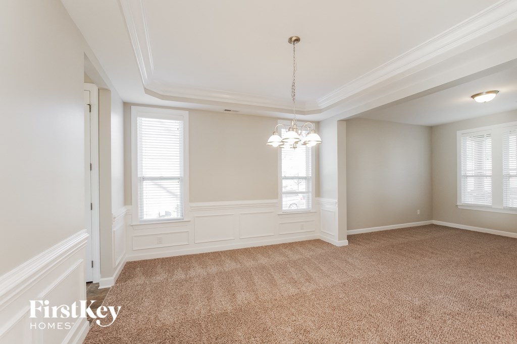 a dining room with a chandelier and a window