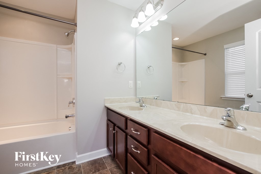 a bathroom with two sinks and a large mirror
