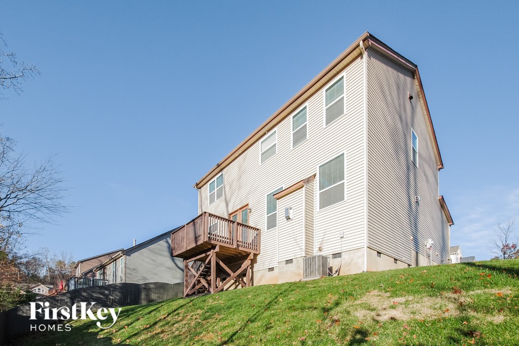 a home with a deck on top of a hill