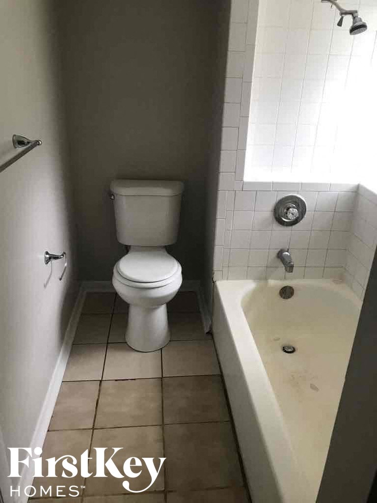 a bathroom with a toilet and a bath tub and a sink