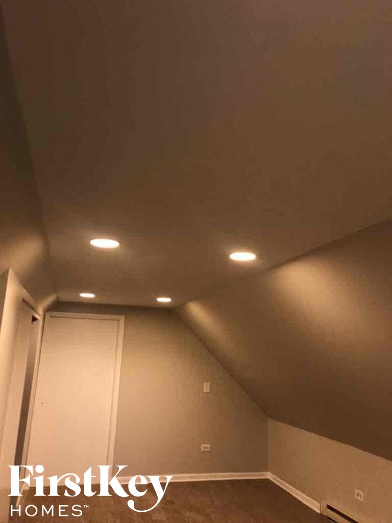 the ceiling of a small room with lights on it