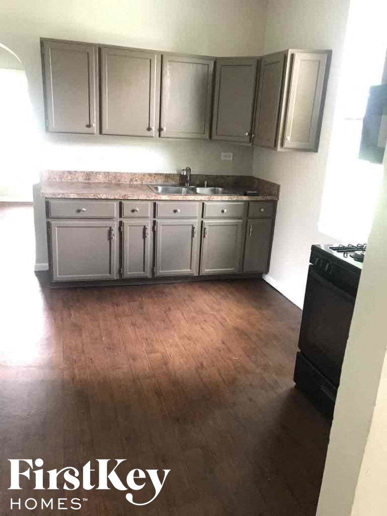 a kitchen with wooden floors and stainless steel cabinets