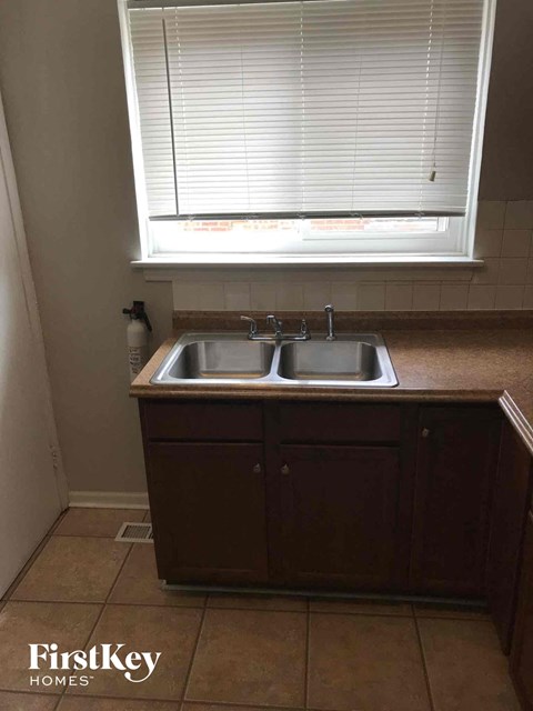 A small kitchen with a sink and a window.