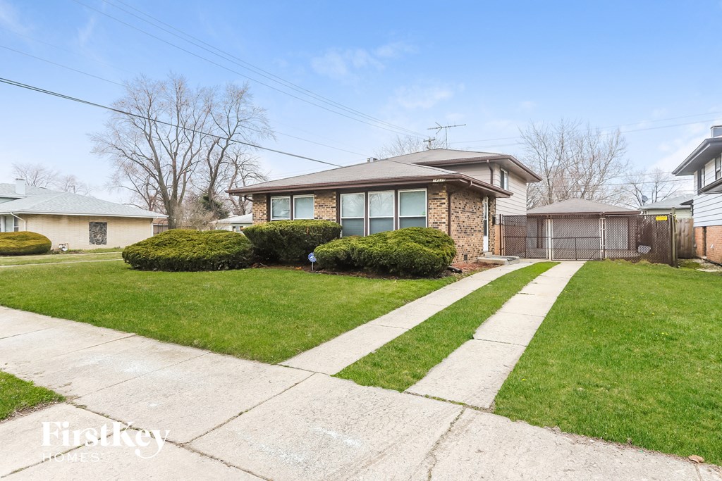 a home with a sidewalk and lawn in front of it