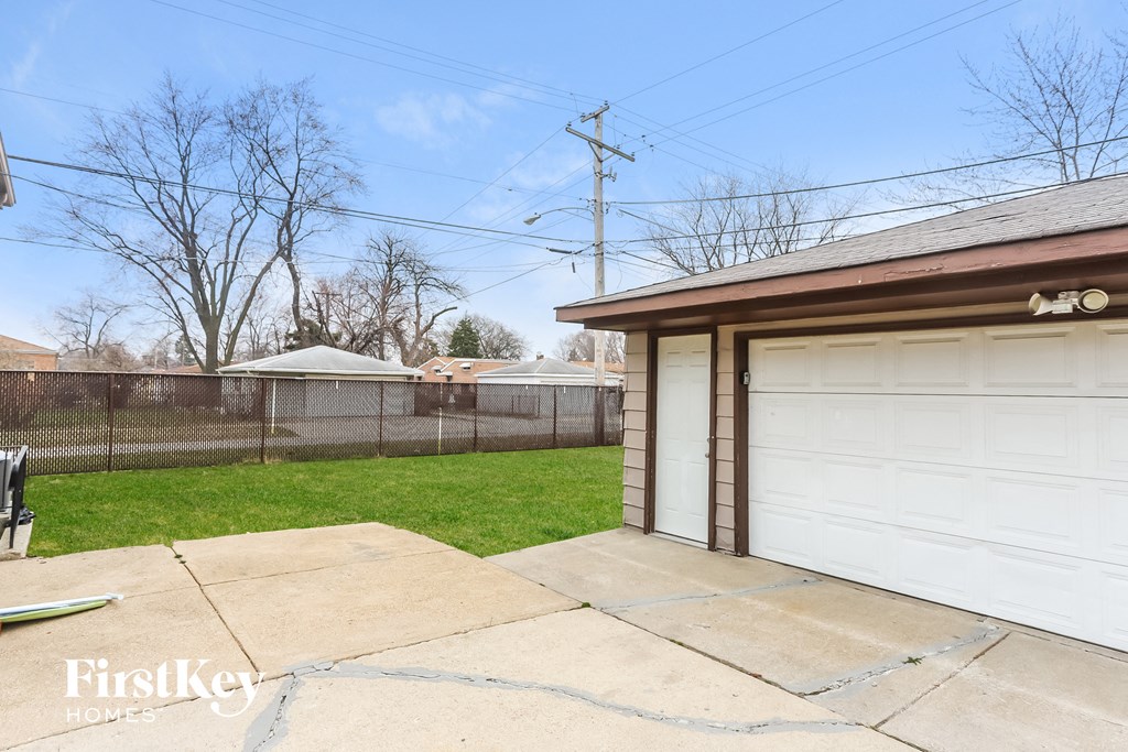 a backyard with a garage and a white garage door