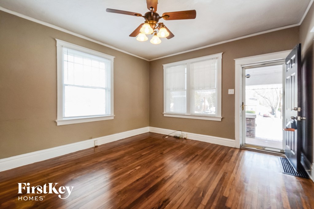 A room with wooden floors and a ceiling fan.