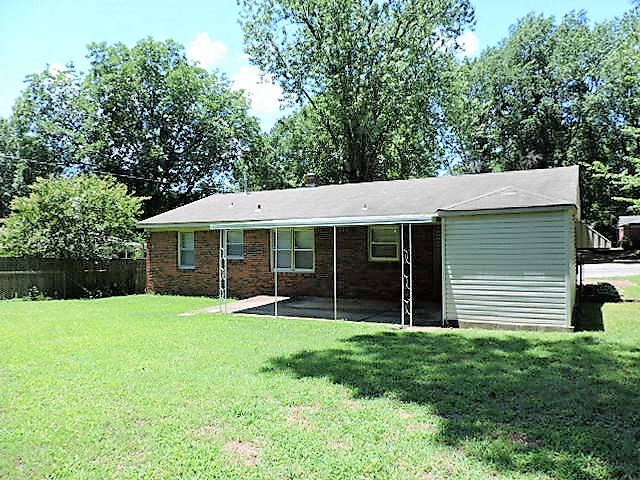 A house with a grey roof and a garage door.