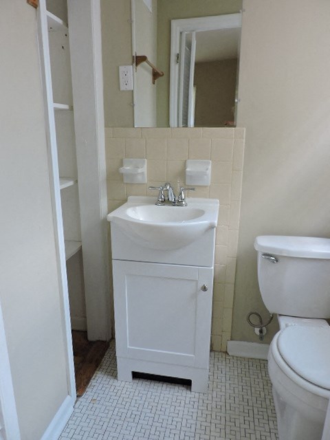A white sink and toilet in a small bathroom.
